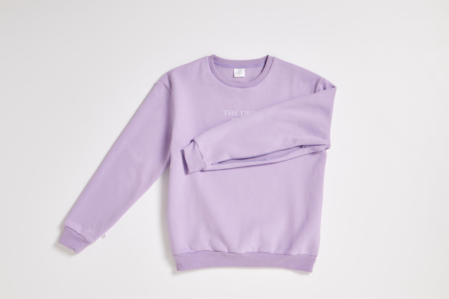 The Drip Crew Lavender flat lay showing arm zip