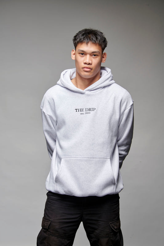 The Drip Hoodie in Light Grey worn by a male model