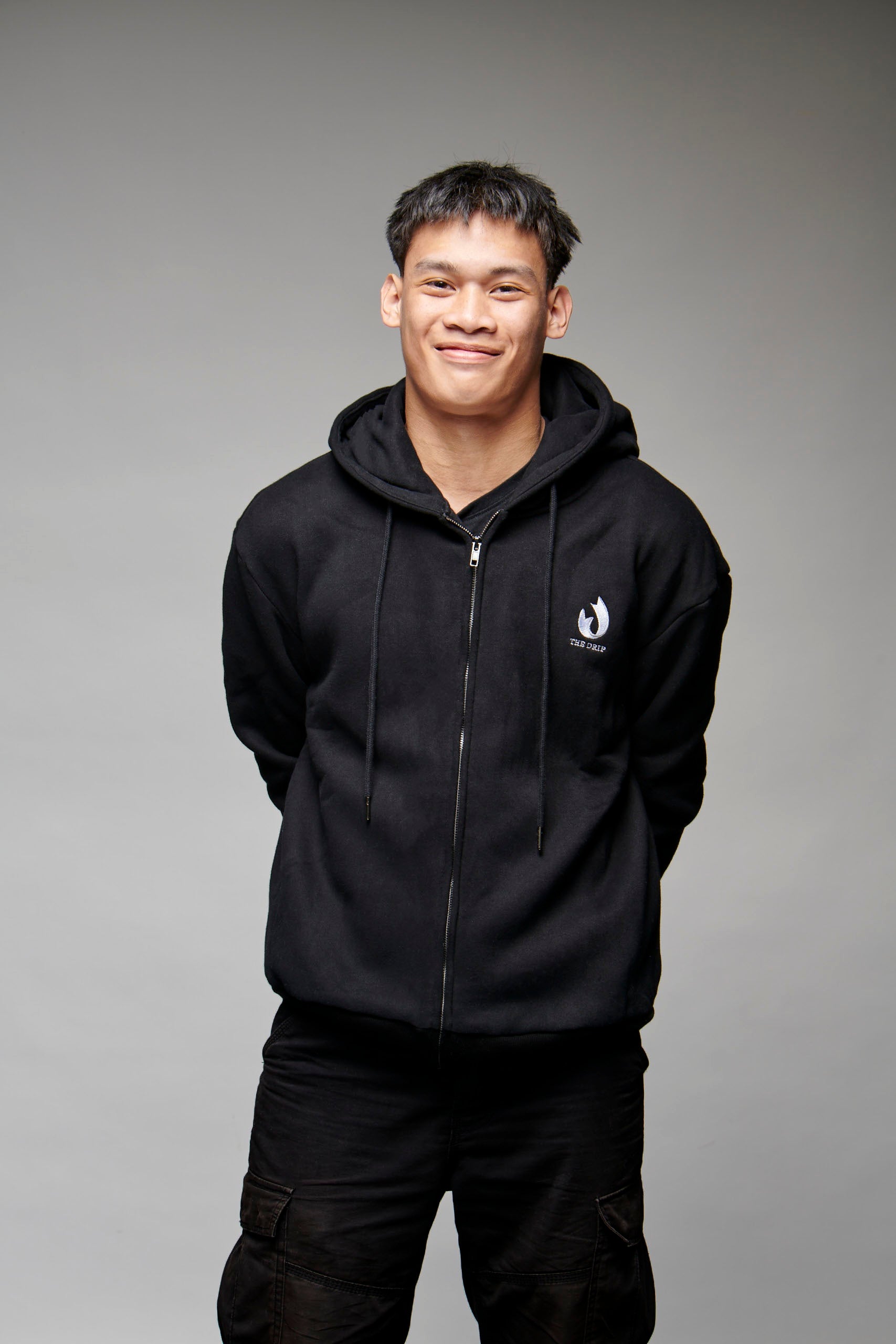 The Drip Zip in Black worn by a male model