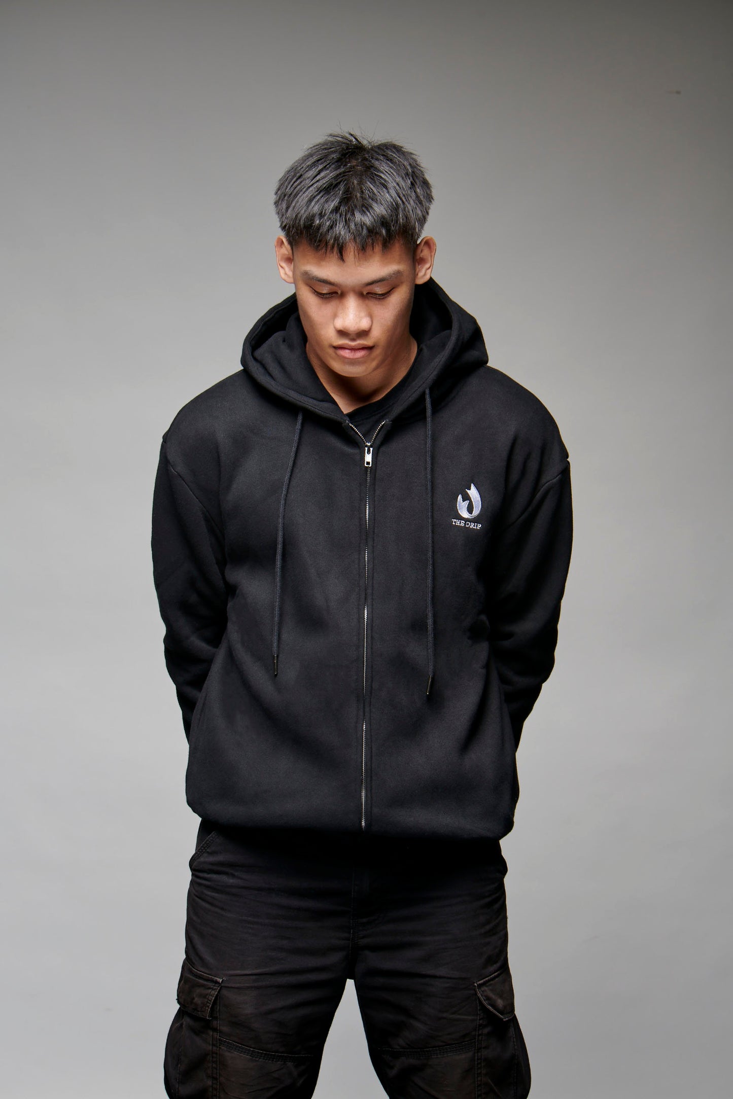 The Drip Zip in Black worn by a male model