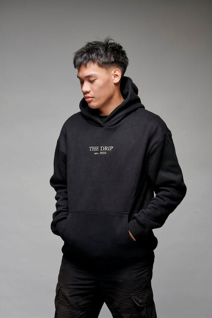 The Drip Hoodie in Black worn by a male model