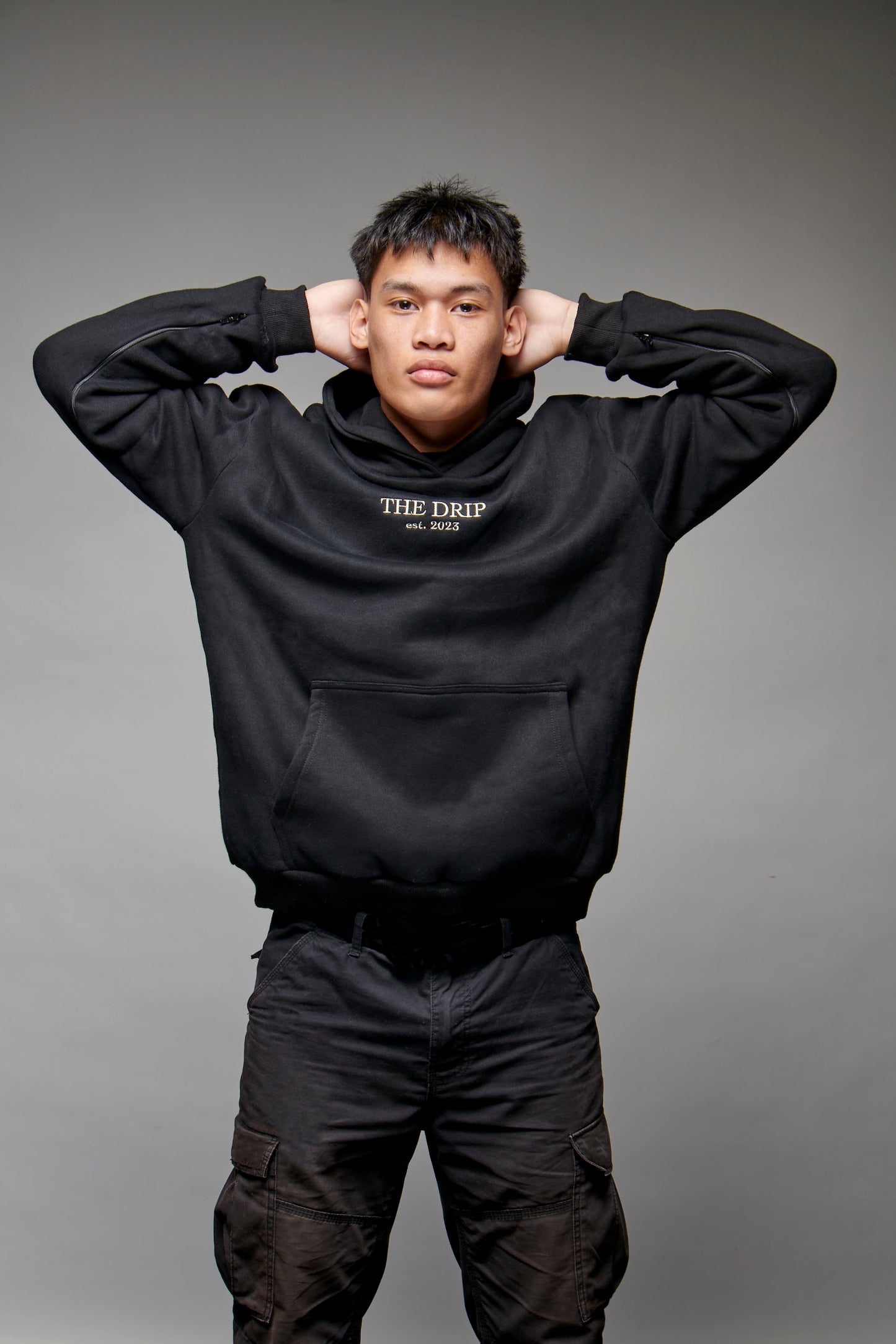 The Drip Hoodie in Black worn by a male model