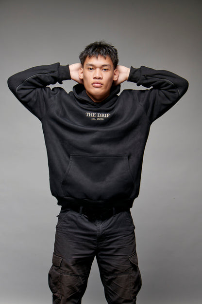 The Drip Hoodie in Black worn by a male model