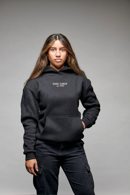 The Drip Hoodie in Black worn by a female model