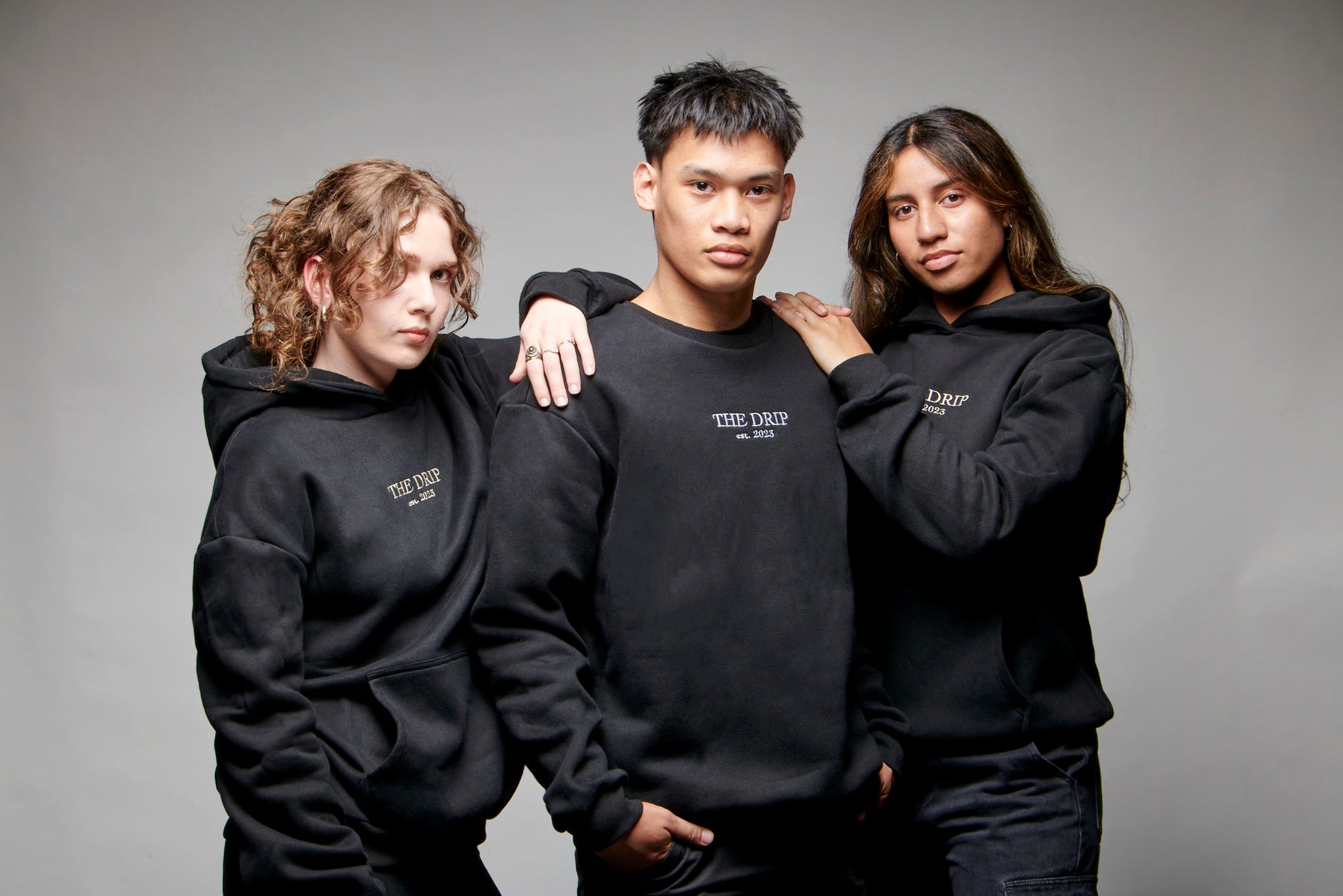 Three models wearing The Drip Crew Black